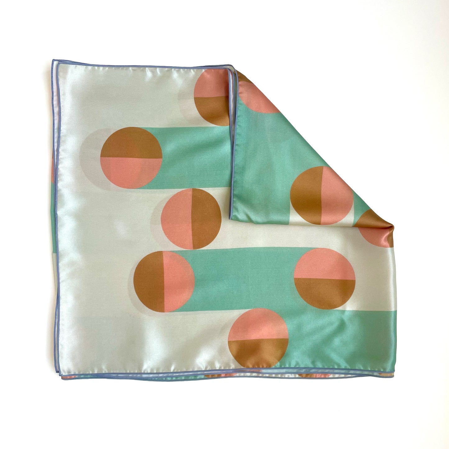 Add a touch of luxury to your outfit with this art deco inspired geometric print silk scarf. Attach it to your purse or wear as a hair wrap for the designer look