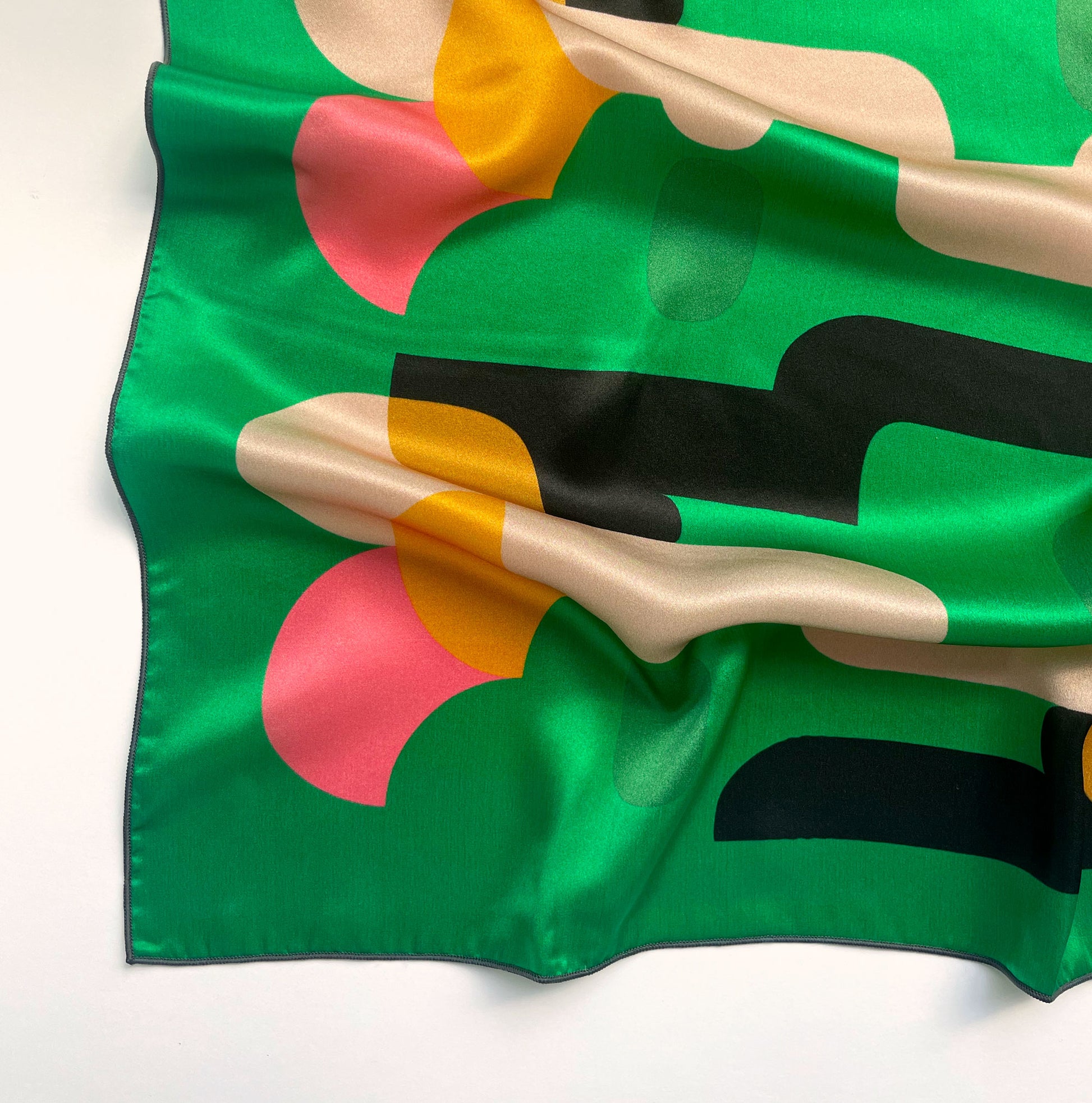 The retro abstract shape of Green Meanies has a modern feel that's easy to wear as a neck scarf, hair scarf, or accessorize your purse with.