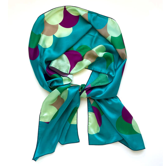 Pure luxury in a scarf. Bold greens and teals pair with creams in this long silk charmeuse scarf. Ideal as a head scarf or hair wrap