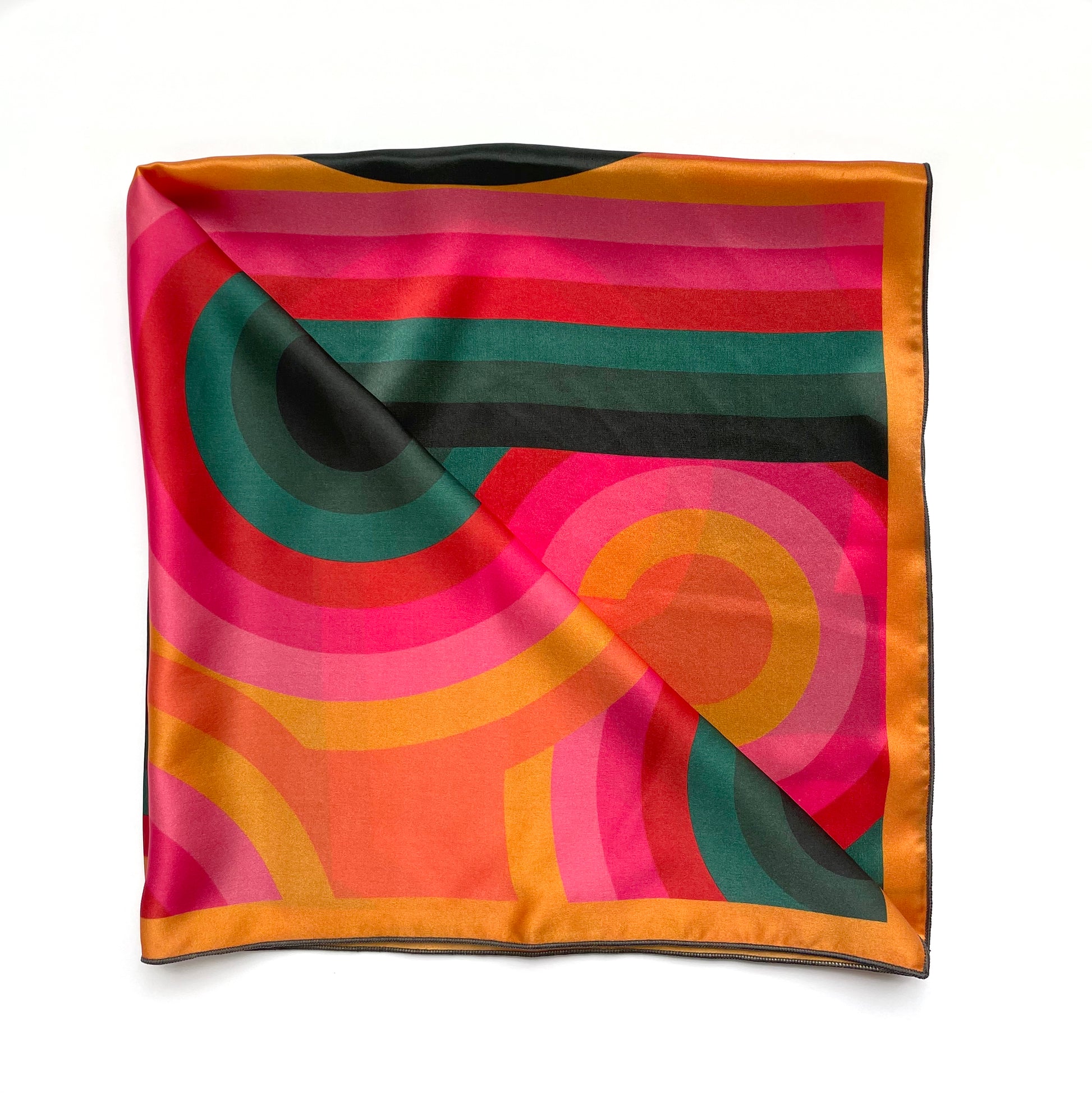 Our bestselling square silk scarf, the Lolly has a retro geometric print and colorful design that is beautiful as a head scarf, neck scarf, or tied to your purse