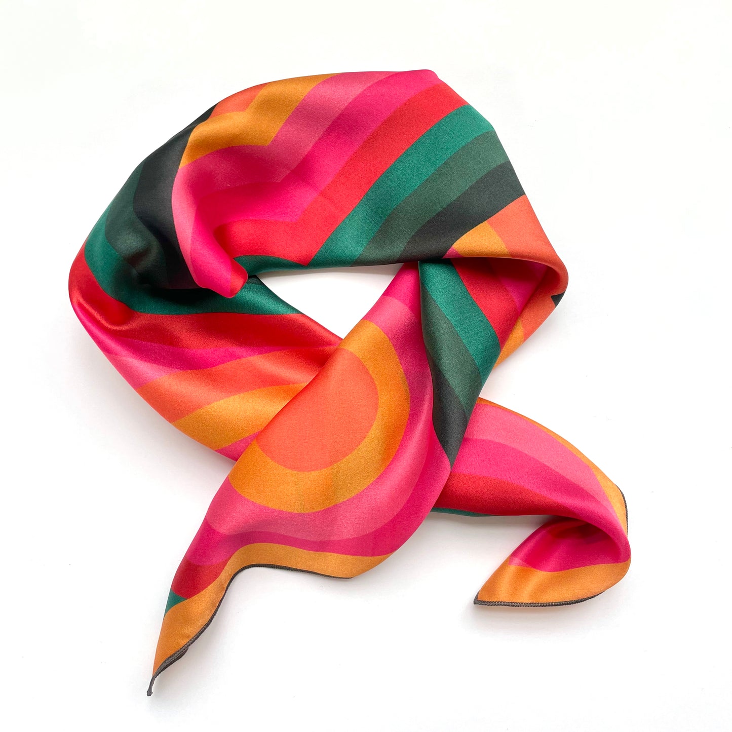 The Lolly is a luxury silk scarf that adds punch to fall and winter wardrobe with its rich colors, this square silk scarf  is great worn as a neckerchief or hair scarf