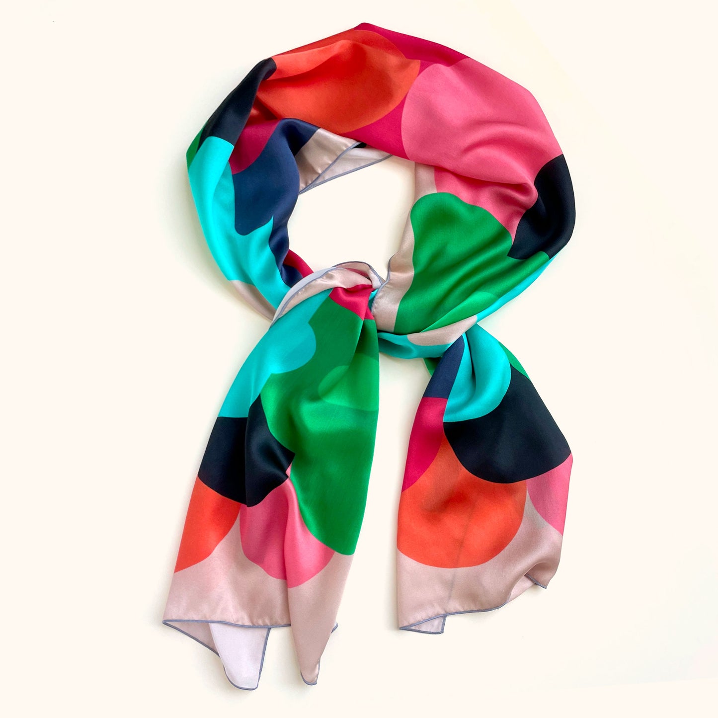 Bold designer retro long silk scarf. With pink, green, red and black for drama, this takes scarves to the max! What outfit doesn't match this scarf? Wear this in your hair, or on your purse for that touch of luxury
