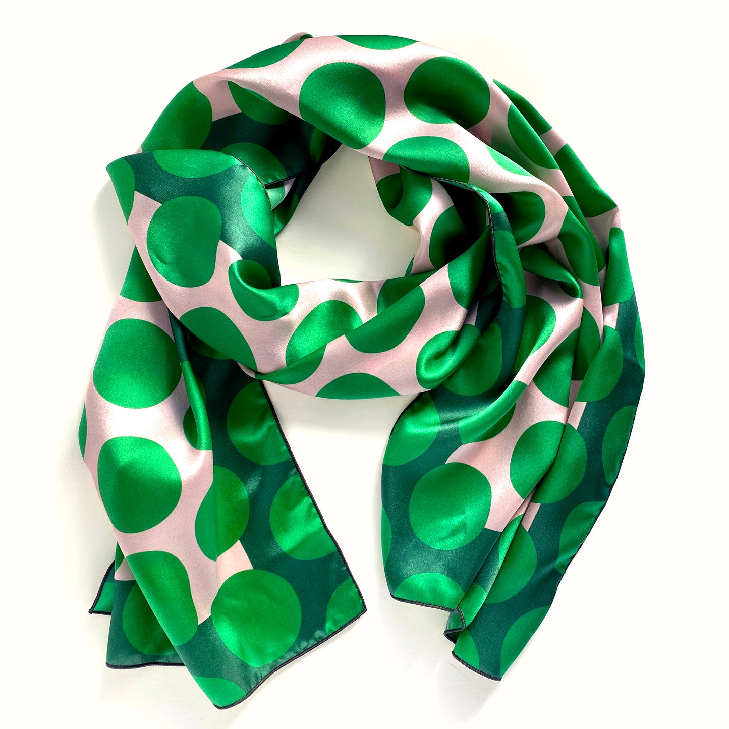 A modern twist on an old favorite. The Polka is a long 100% silk scarf in bold greens and white