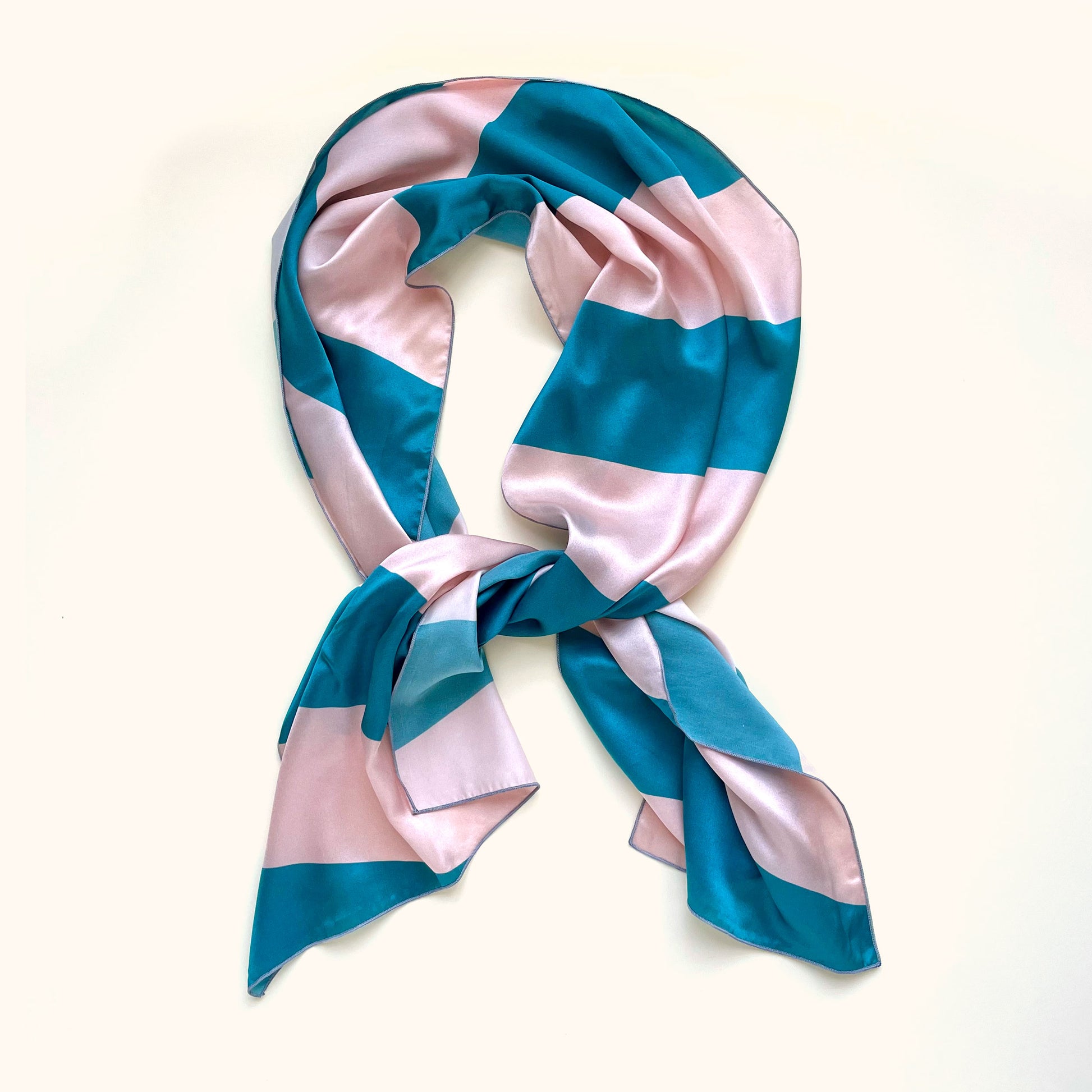 Bold blue rugby stripes and classic preppy vibes on this 100% silk, long scarf, perfect for adding luxury to your outfit