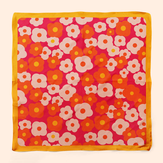 A square silk floral scarf with retro flowers in orange pink and yellow. Colorful neckerchief or hair scarf.