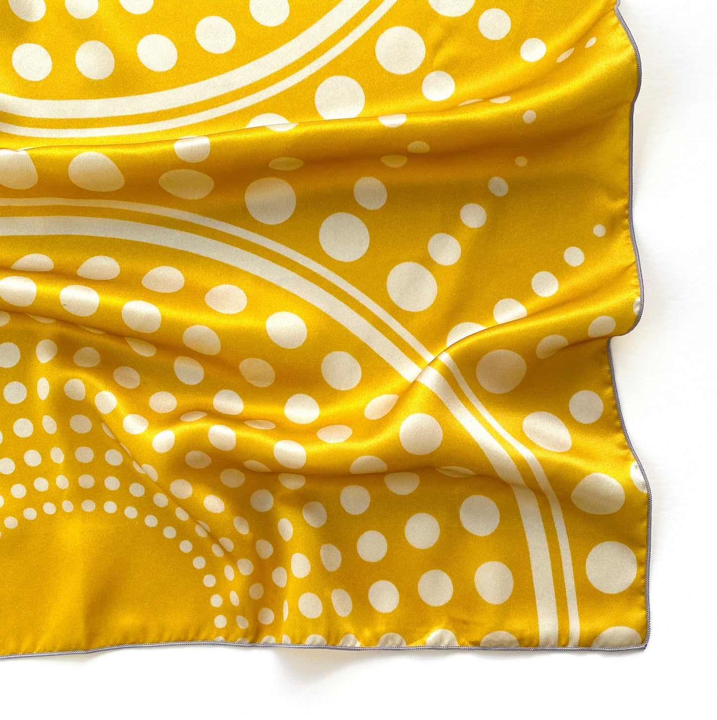 Bring some extra sparkle into your day with this sunshine inspired 100% silk square scarf. Experiment as a bandana or attach it to your purse